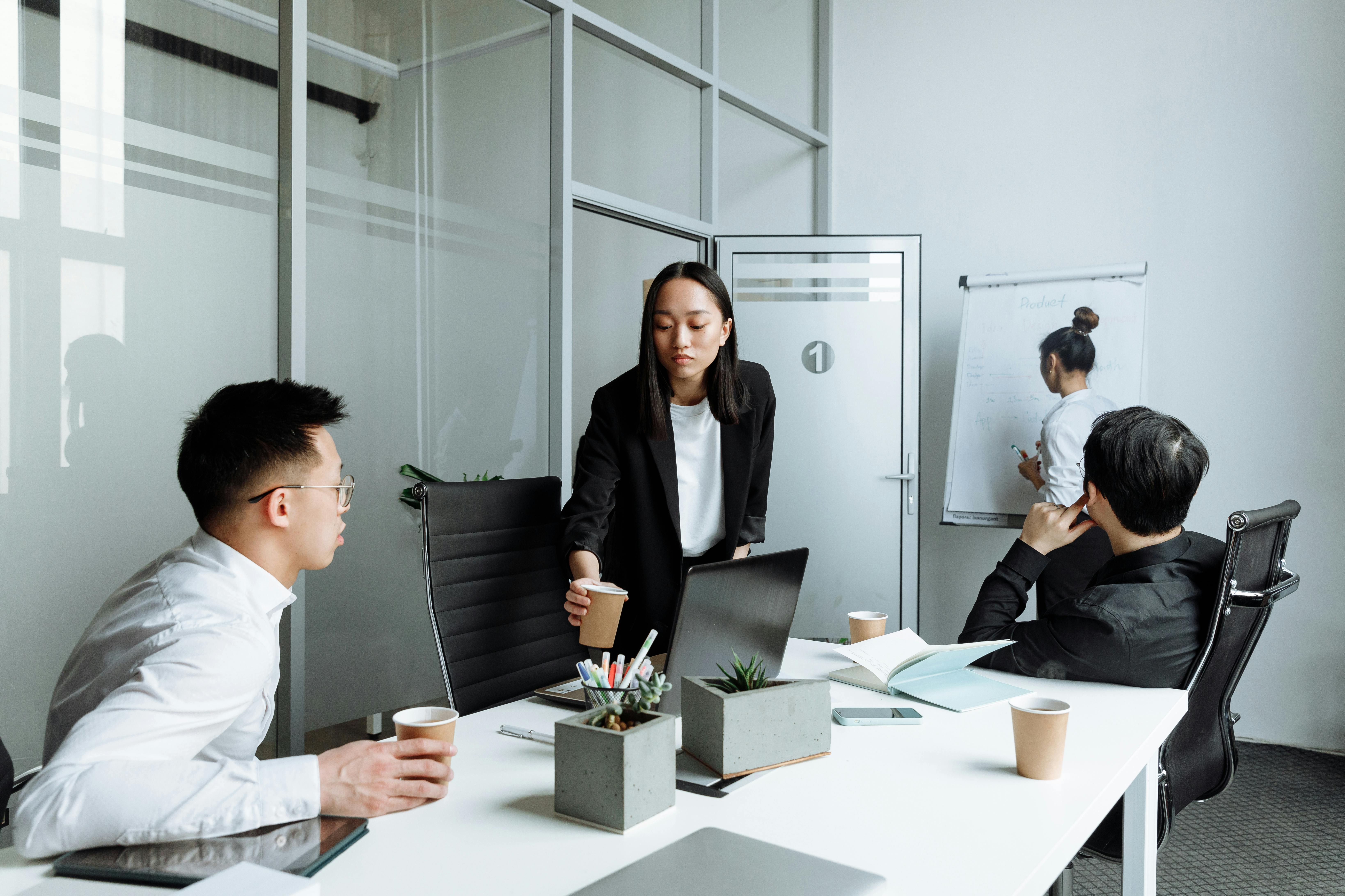 Diverse office team engaged in a collaborative meeting discussing business strategies.